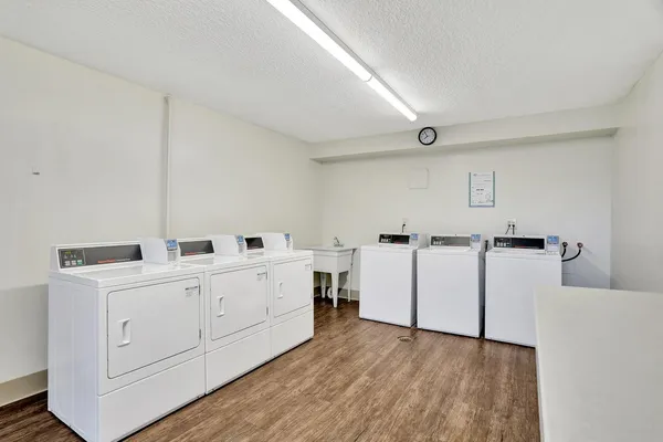 a kitchen with white cabinets and white appliances