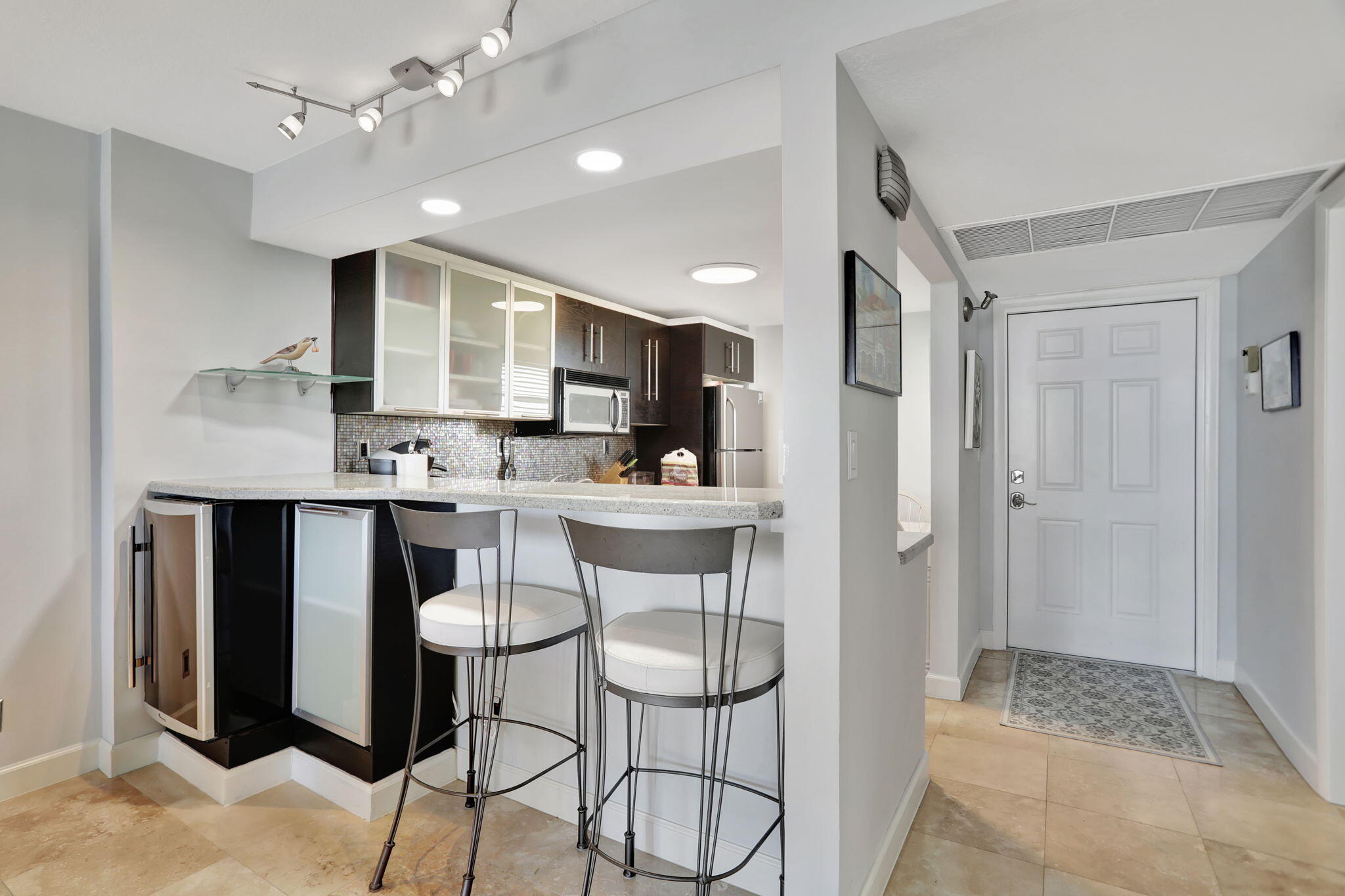 4 Royal Palm Way, Unit 6020 Boca Raton, FL 33432 - Photo 9 of 41 a kitchen with stainless steel appliances kitchen island granite countertop a refrigerator and a stove top oven