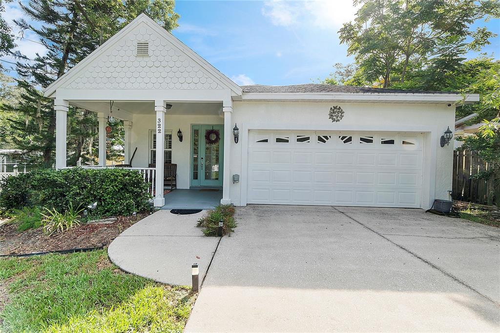 322 North Rhodes Street Mount Dora, FL 32757 - Photo 1 of 1 a view of a white house with a yard and plants