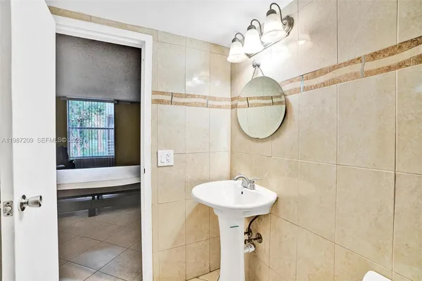 a bathroom with a sink a mirror and a shower