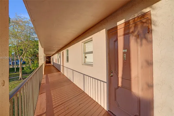 a view of a balcony with wooden floor