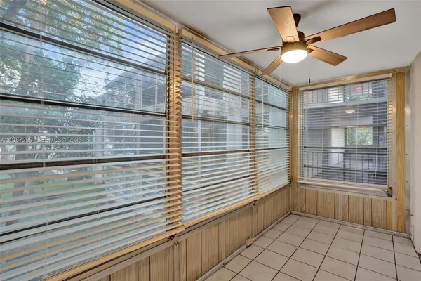 a view of a balcony with a potted plant on a brick wall