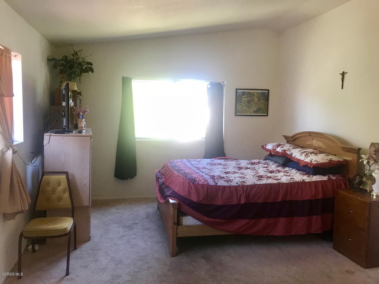 500 Percy Street, Unit 54 Oxnard, CA 93033 - Photo 9 of 9 a bedroom with a bed chair and window