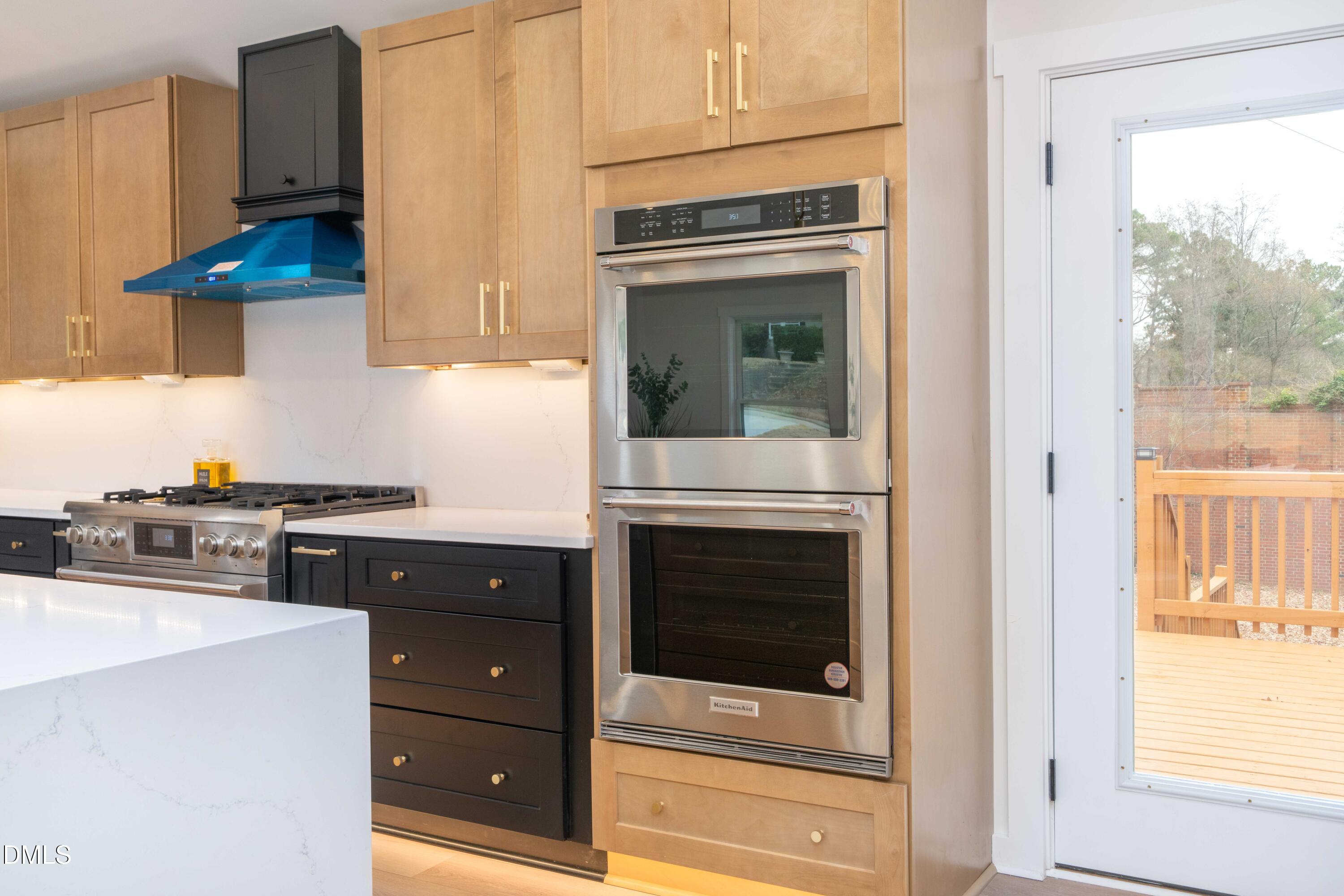 721 Currituck Drive Raleigh, NC 27609 - Photo 11 of 81 a kitchen with stainless steel appliances granite countertop a stove and a microwave