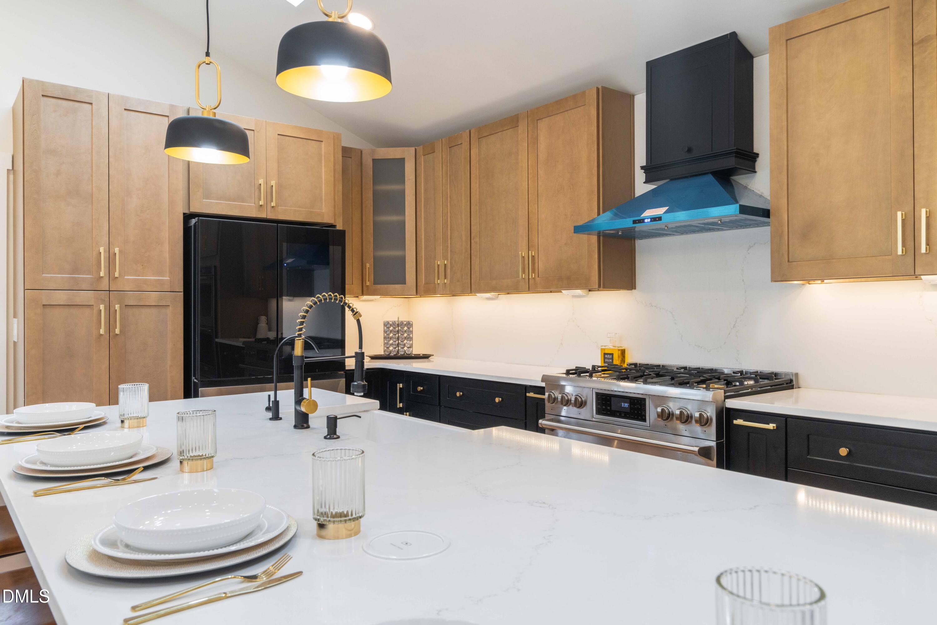 721 Currituck Drive Raleigh, NC 27609 - Photo 12 of 81 a kitchen with stainless steel appliances a sink a stove a refrigerator and cabinets
