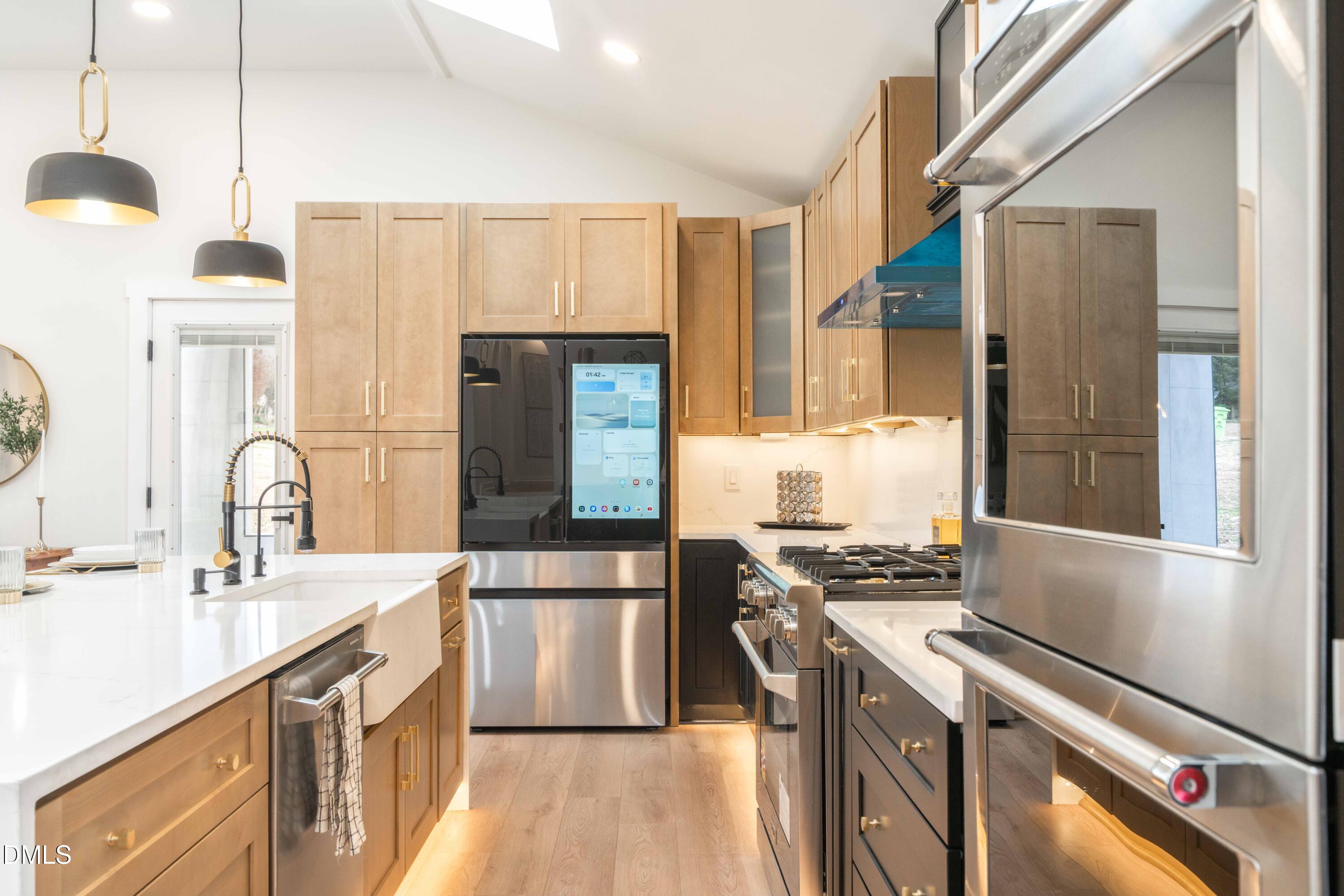 721 Currituck Drive Raleigh, NC 27609 - Photo 15 of 81 a kitchen with stainless steel appliances granite countertop a sink a stove and a refrigerator