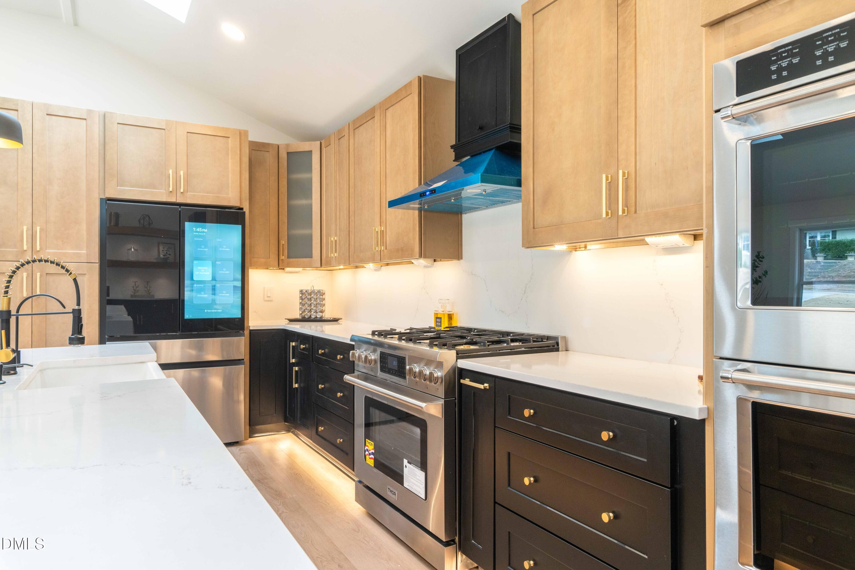 721 Currituck Drive Raleigh, NC 27609 - Photo 16 of 81 a kitchen with stainless steel appliances granite countertop a stove a sink and a refrigerator