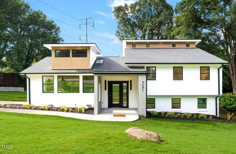 a large kitchen with stainless steel appliances kitchen island granite countertop a large cabinets a sink and a counter top space