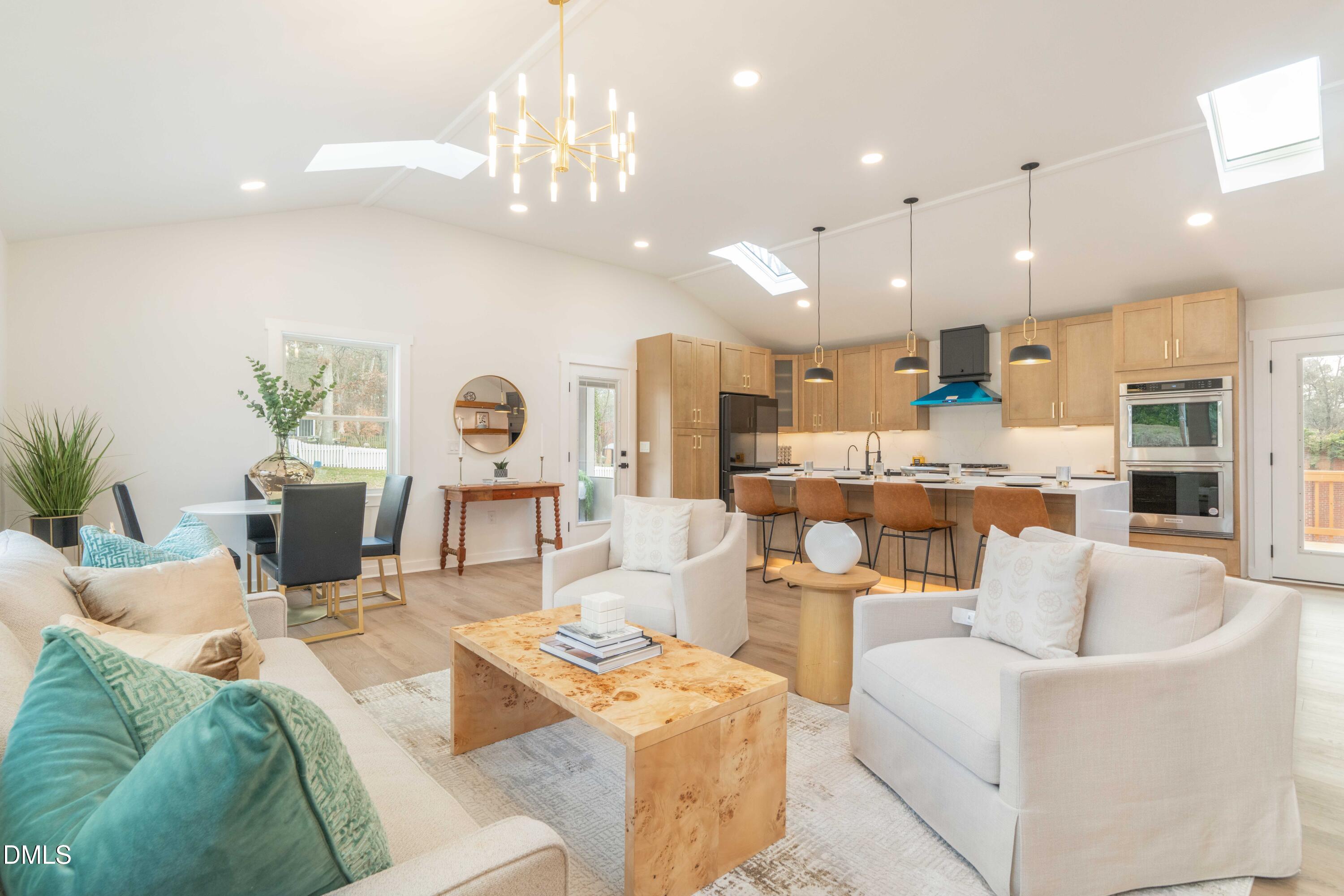 721 Currituck Drive Raleigh, NC 27609 - Photo 21 of 81 a living room with furniture kitchen view and a chandelier