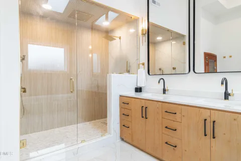 a bathroom with a glass shower door and a glass door