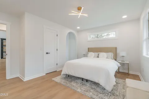 a view of an empty room with a window and closet