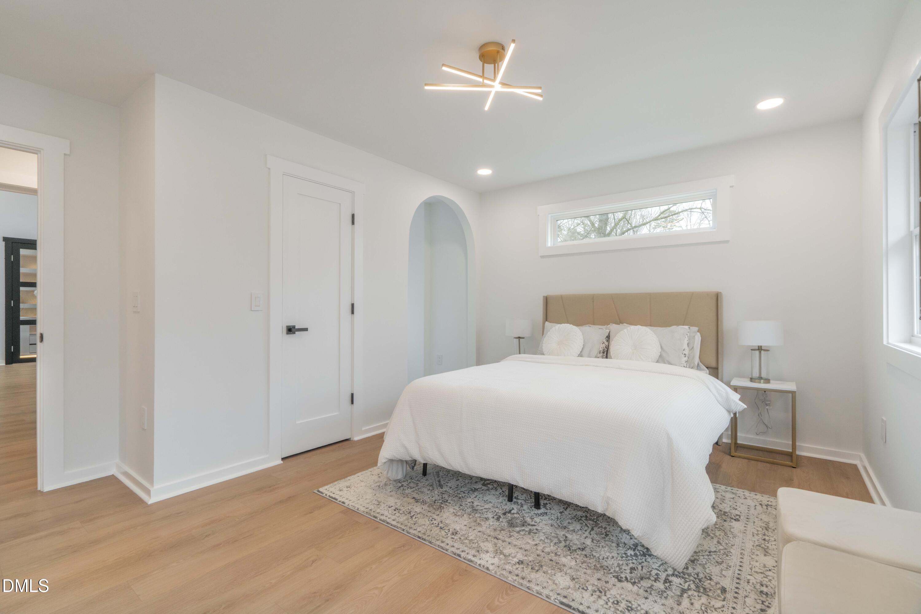 721 Currituck Drive Raleigh, NC 27609 - Photo 42 of 81 a bedroom with a bed and a lamp