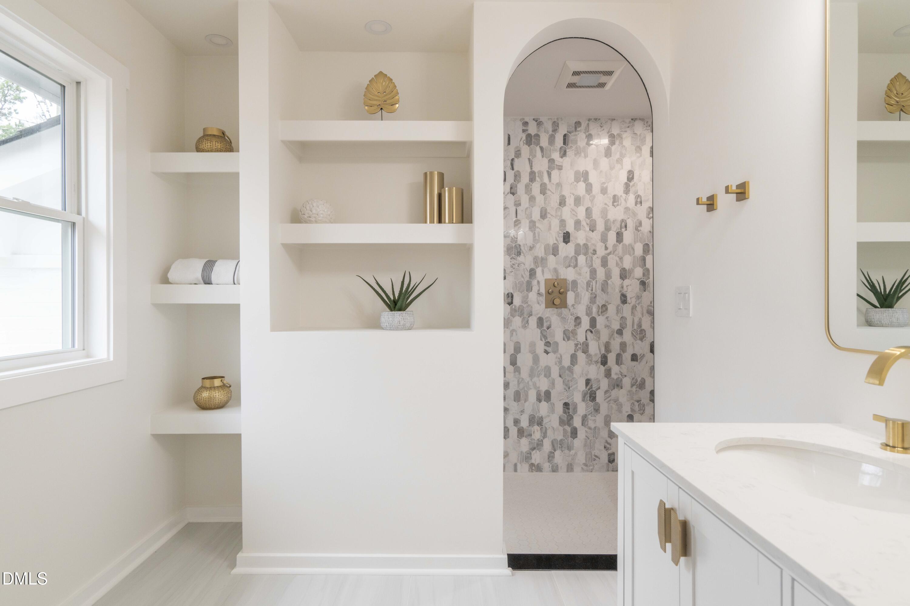 721 Currituck Drive Raleigh, NC 27609 - Photo 45 of 81 a bathroom with a sink a toilet and a mirror