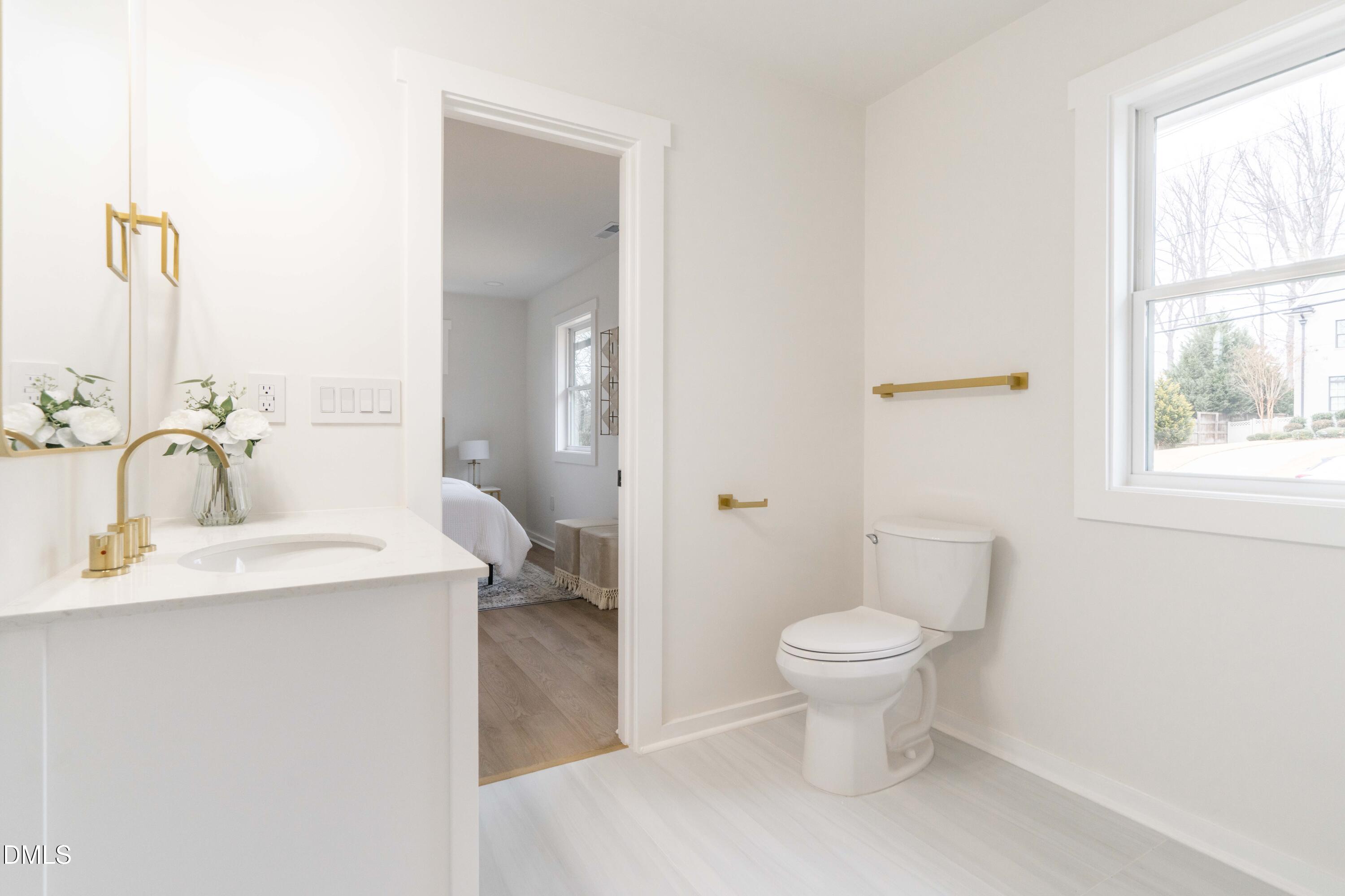 721 Currituck Drive Raleigh, NC 27609 - Photo 48 of 81 a bathroom with a sink toilet and a mirror