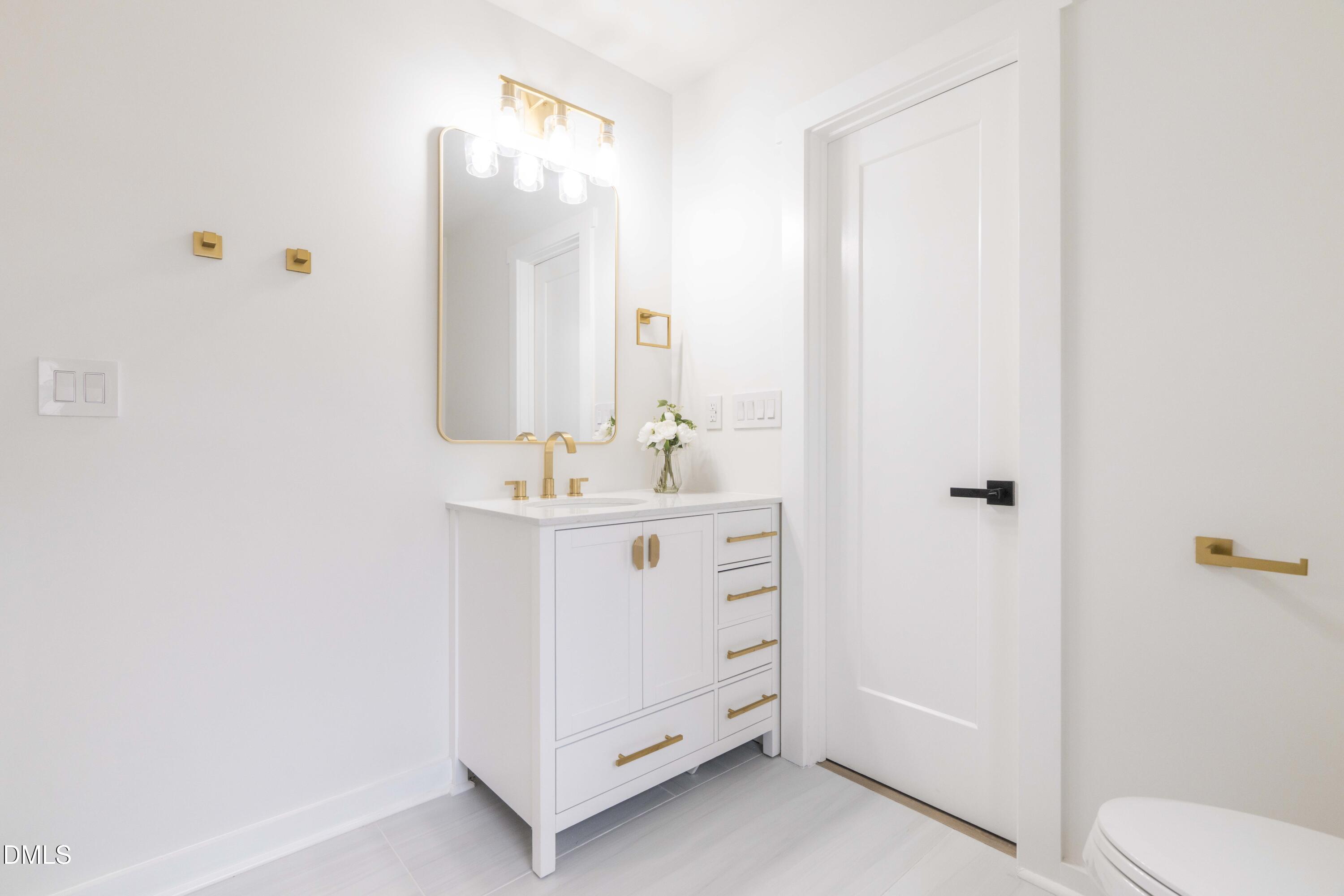 721 Currituck Drive Raleigh, NC 27609 - Photo 49 of 81 a bathroom with a sink mirror and toilet
