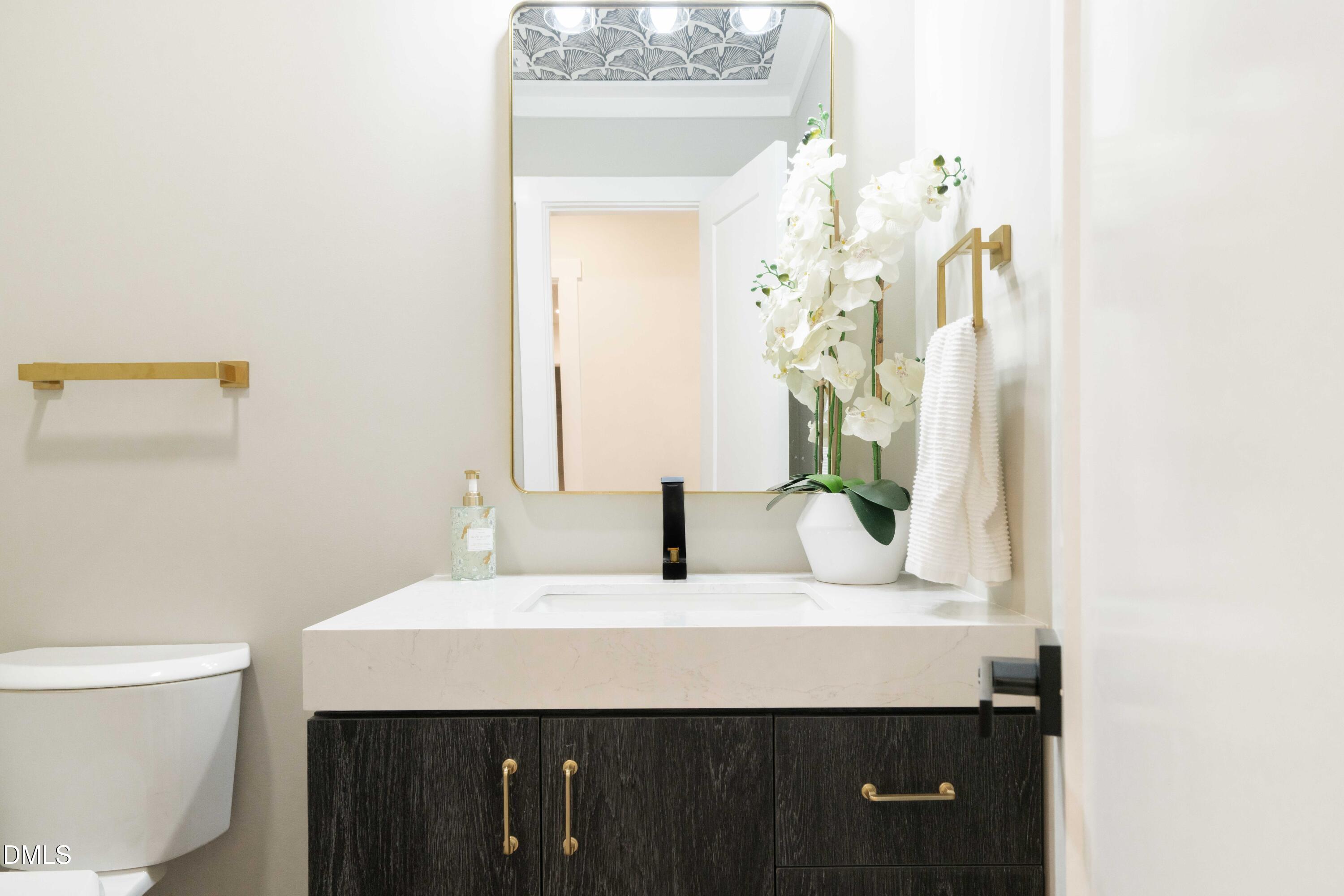 721 Currituck Drive Raleigh, NC 27609 - Photo 60 of 81 a bathroom with a sink and a mirror