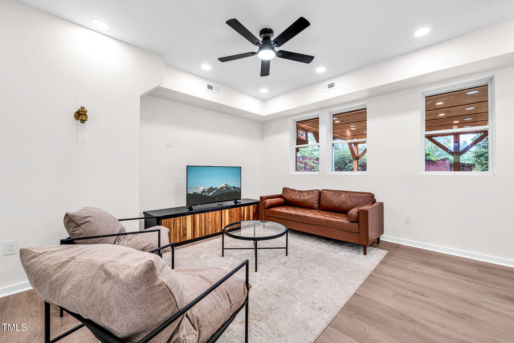 721 Currituck Drive Raleigh, NC 27609 - Photo 64 of 81 a living room with furniture and a flat screen tv
