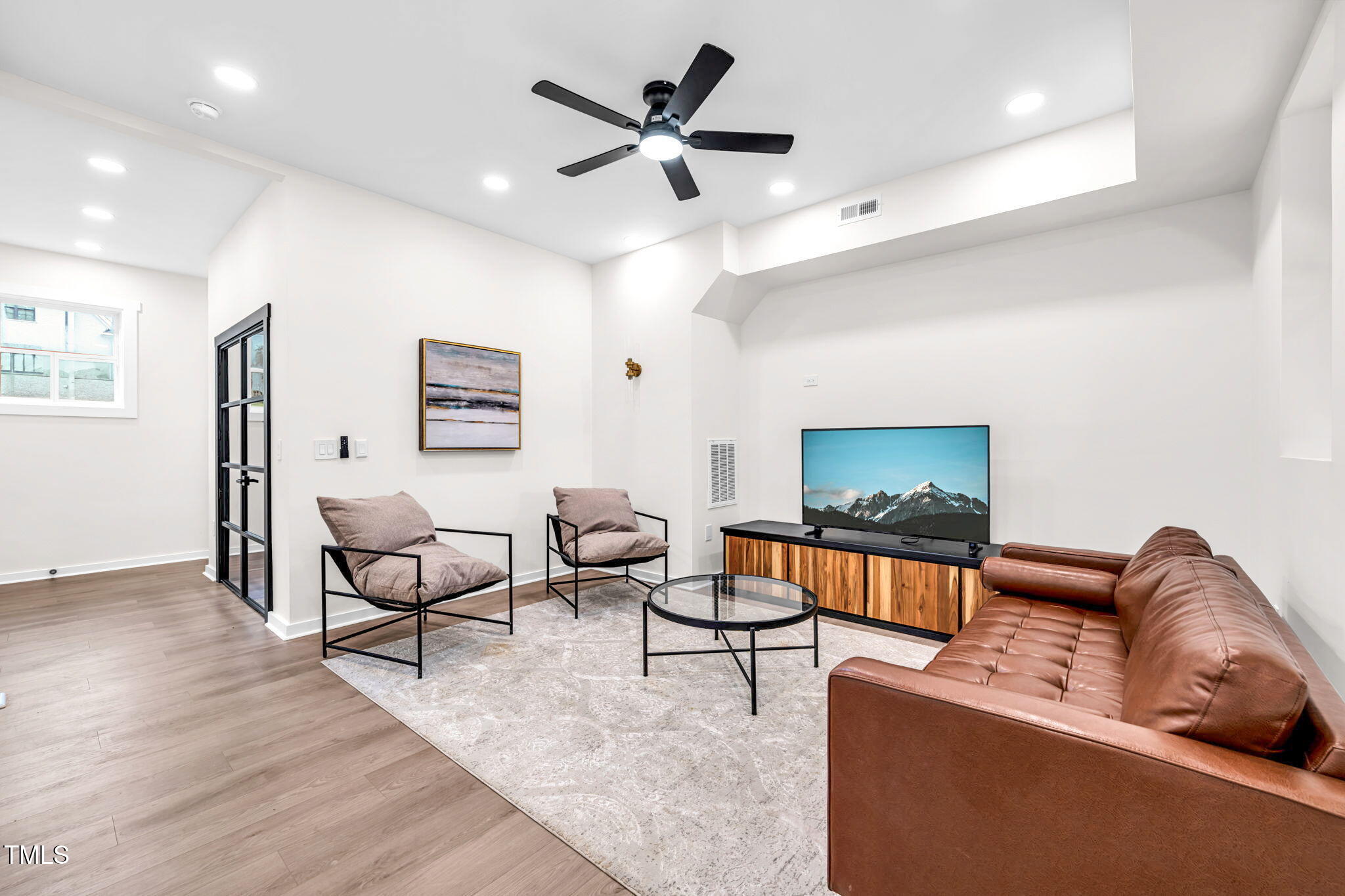 721 Currituck Drive Raleigh, NC 27609 - Photo 65 of 81 a living room with furniture and a flat screen tv