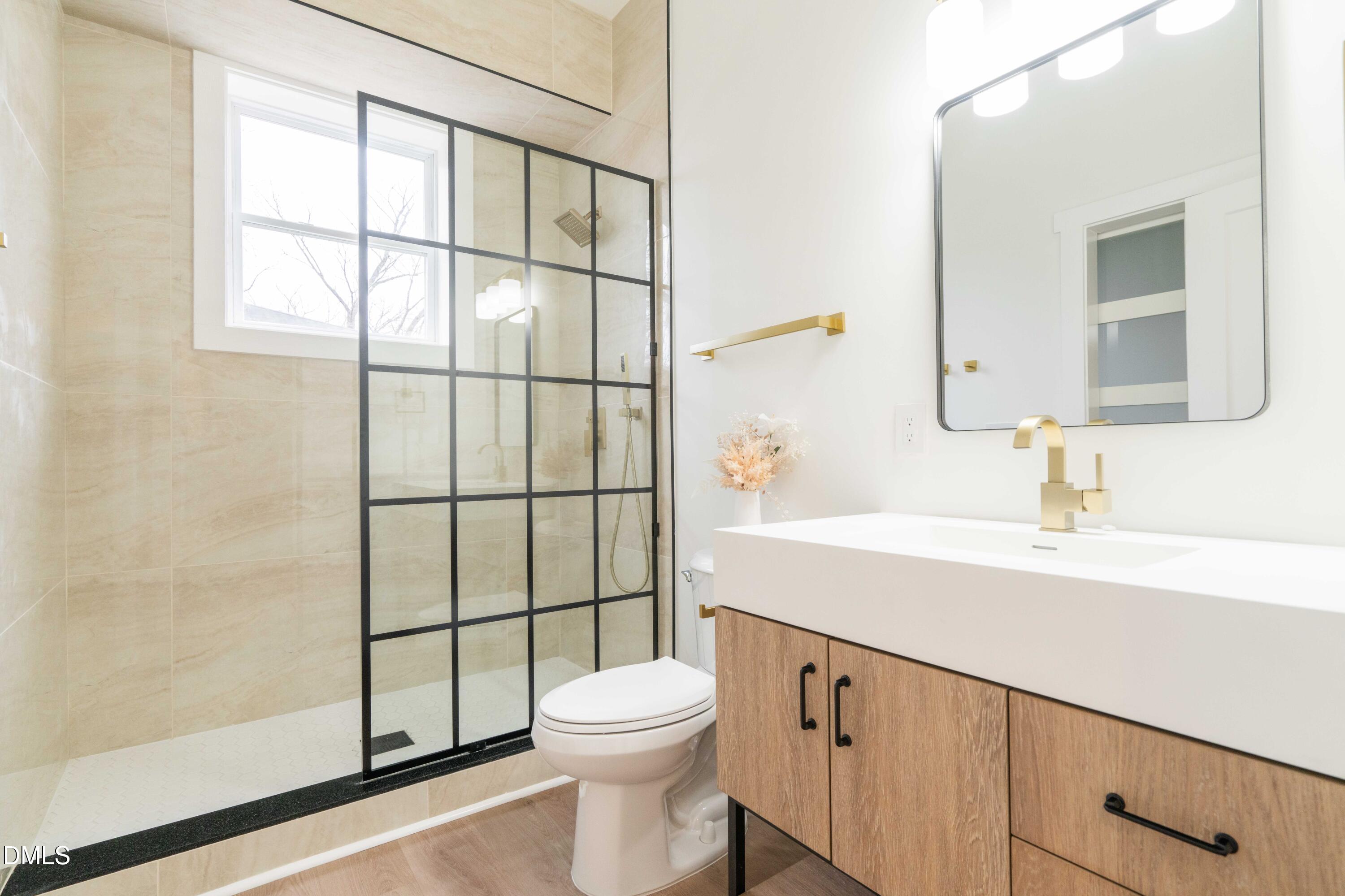 721 Currituck Drive Raleigh, NC 27609 - Photo 69 of 81 a bathroom with a sink a toilet and shower