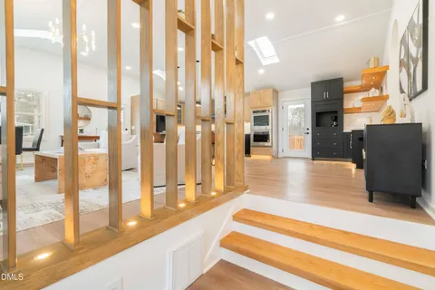 a kitchen with stainless steel appliances granite countertop a sink a stove and a refrigerator