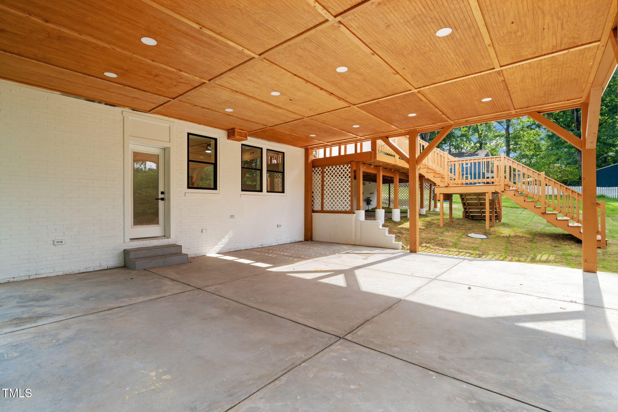 721 Currituck Drive Raleigh, NC 27609 - Photo 72 of 81 a patio with a table and chairs under an umbrella