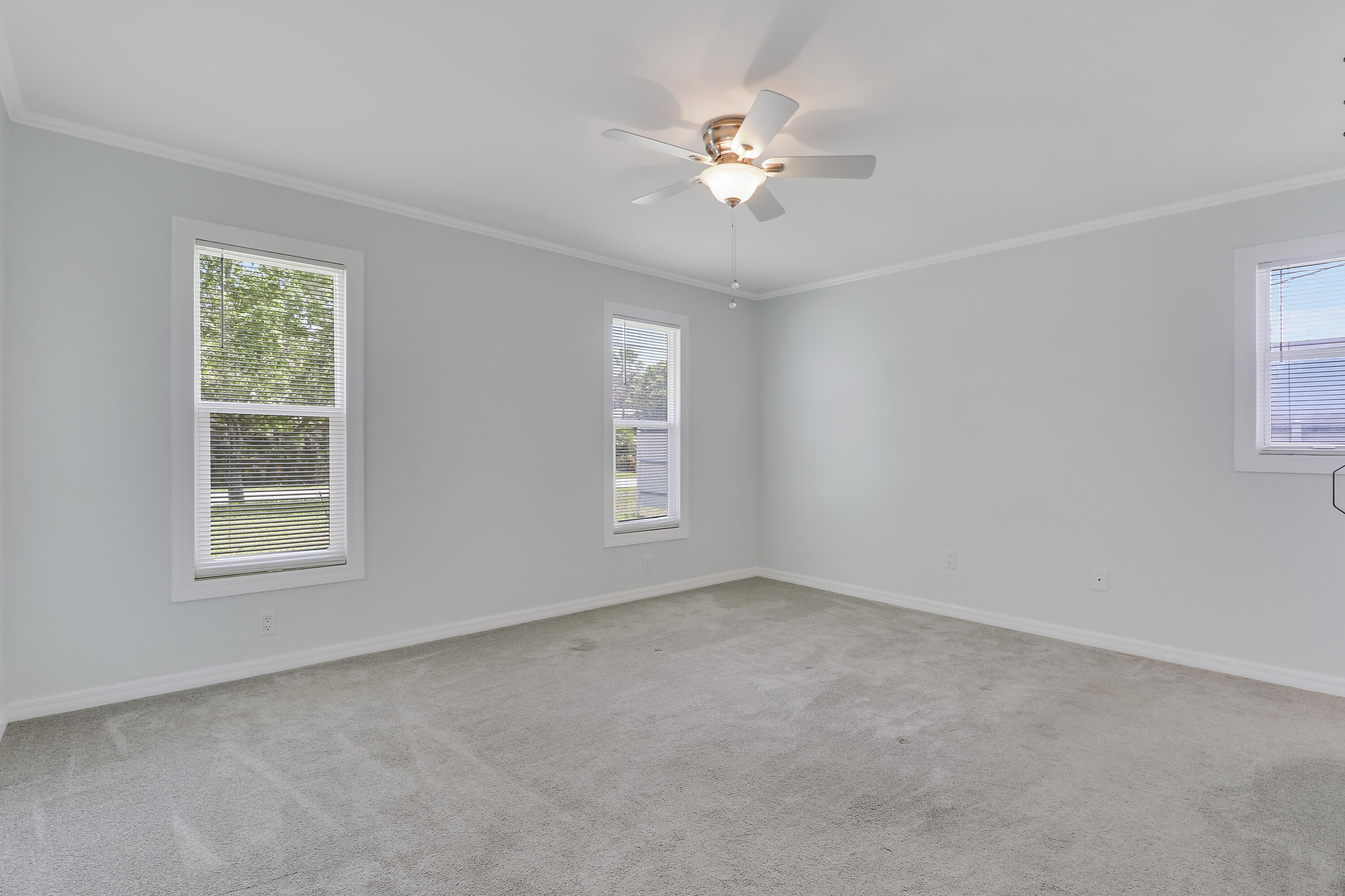 5909 Seagrape Drive Fort Pierce, FL 34982 - Photo 14 of 27 an empty room with windows and fan