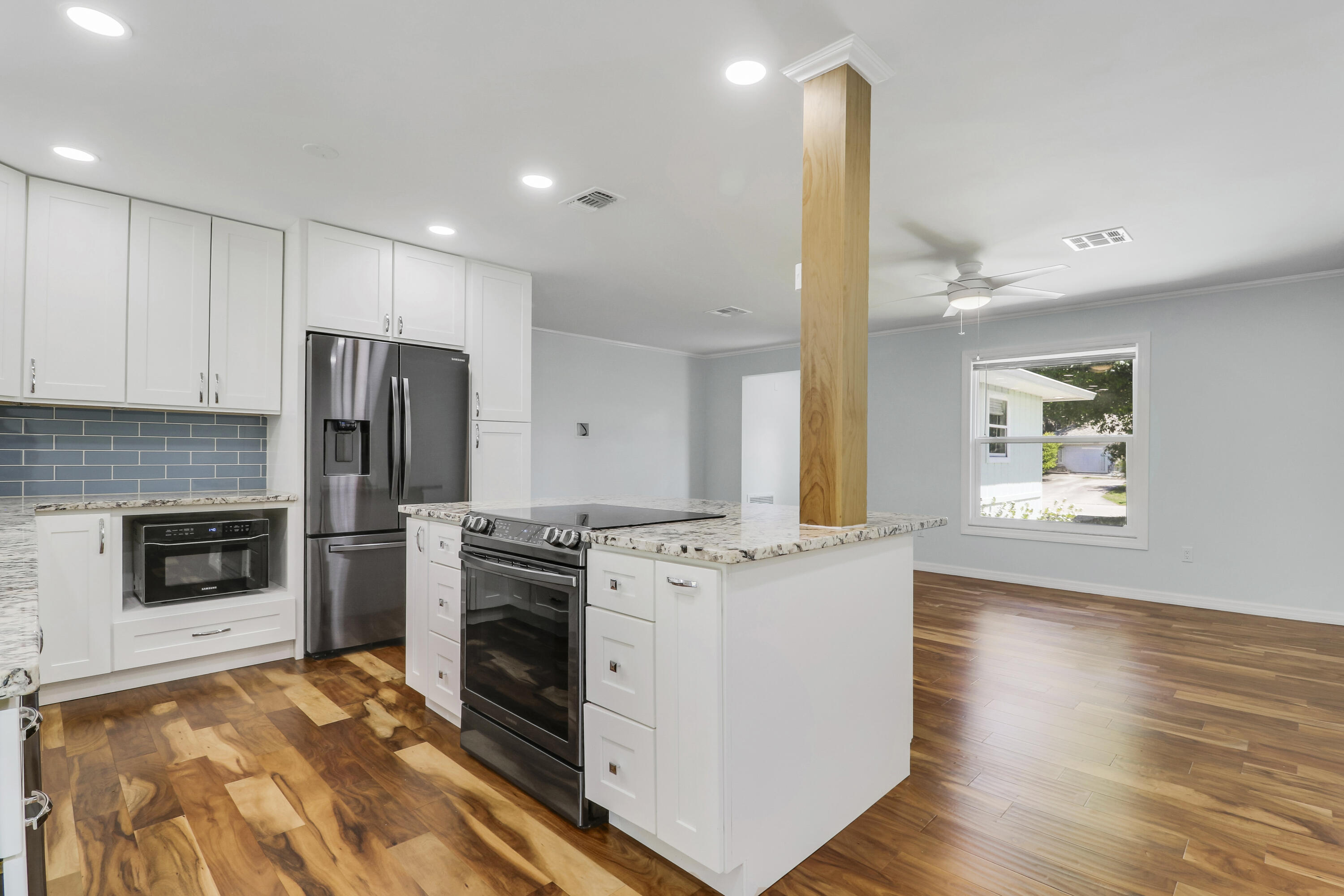 5909 Seagrape Drive Fort Pierce, FL 34982 - Photo 6 of 27 a kitchen with a stove a refrigerator and a sink