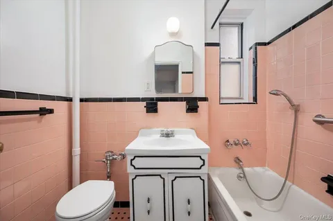 a bathroom with a toilet sink and mirror