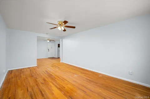 a view of empty room with a fan