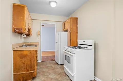 a kitchen with a stove top oven and a refrigerator