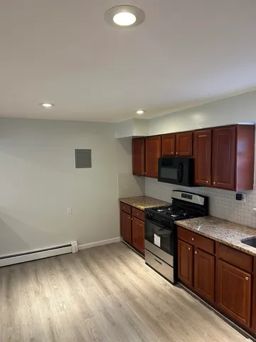 a kitchen with stainless steel appliances granite countertop a stove a sink and a refrigerator