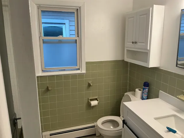a white toilet sitting next to a bathroom sink