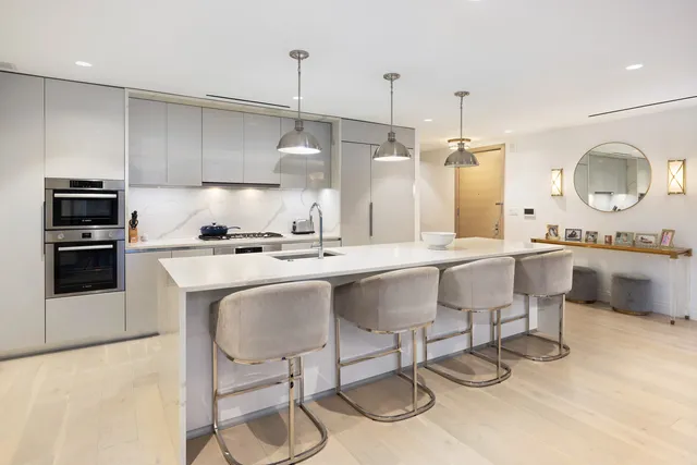 a kitchen with a sink cabinets and stainless steel appliances
