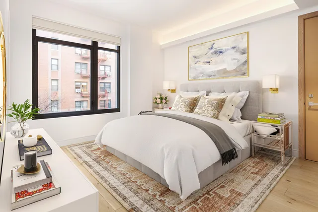 a bedroom with a bed and a large window