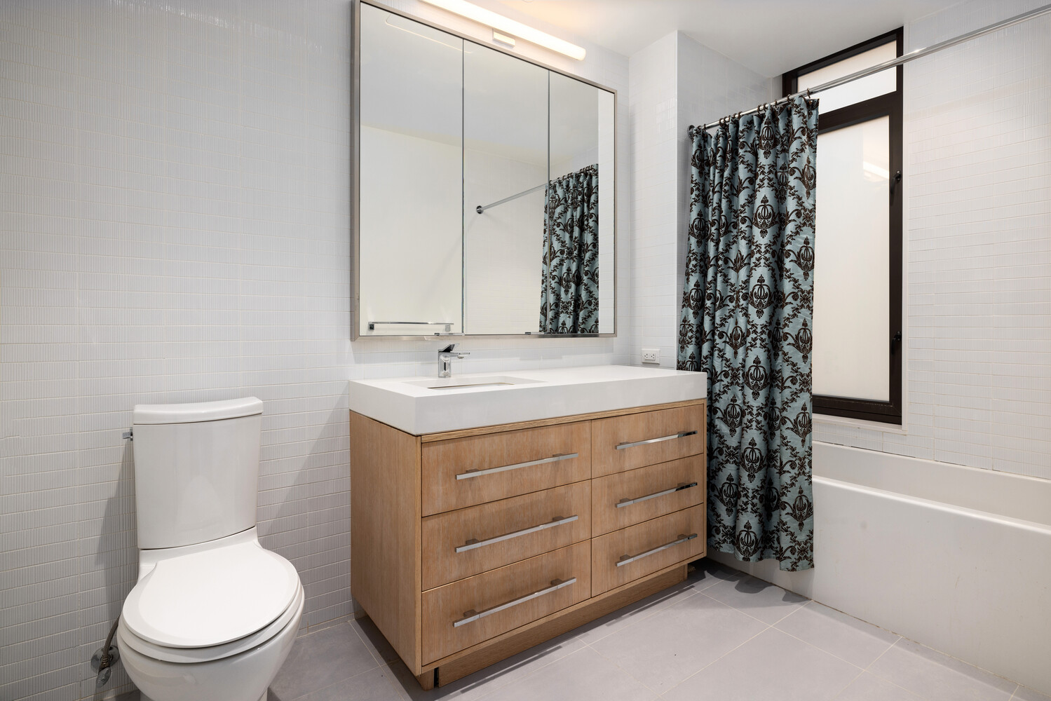 212 West 95th Street, Unit 3B Manhattan, NY 10025 - Photo 7 of 10 a bathroom with a sink a toilet and shower