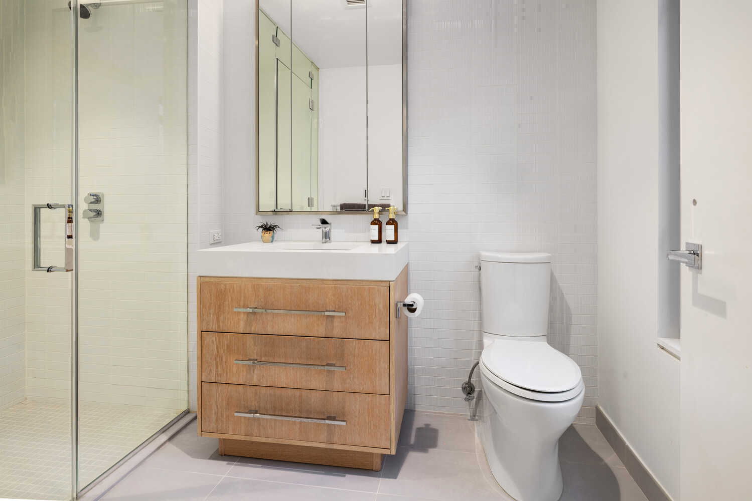 212 West 95th Street, Unit 3B Manhattan, NY 10025 - Photo 9 of 10 a bathroom with a sink a toilet and shower