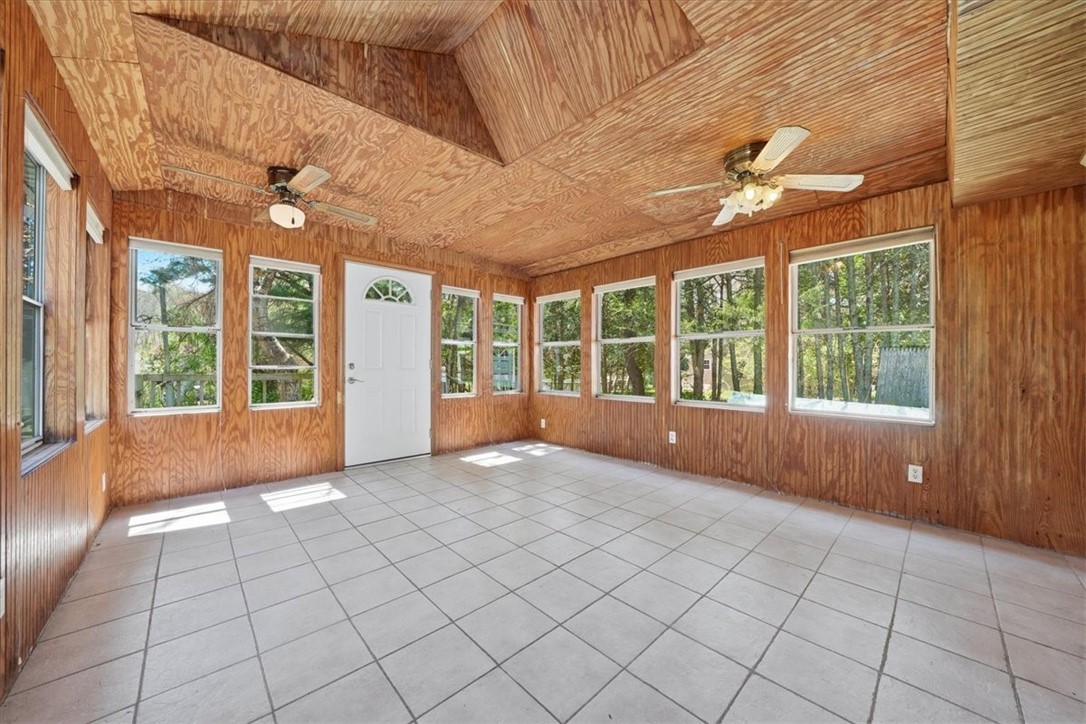 322 Rocky Hill Road Scituate, RI 02857 - Photo 27 of 50 Expansive 3-season room surrounded by walls of windows, bringing the outdoors in and offering a peaceful retreat year-round. Direct access to the exterior makes indoor-outdoor living effortless.