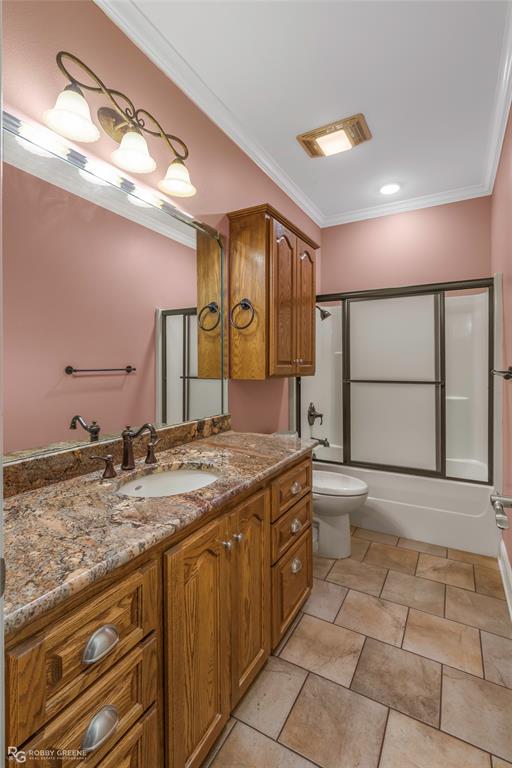 703 Airport Loop Homer, LA 71040 - Photo 20 of 32 a bathroom with a granite countertop sink and a mirror