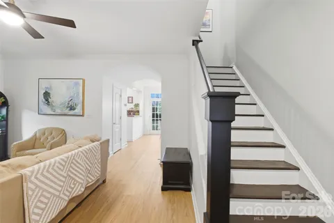 a bedroom with furniture and wooden floor