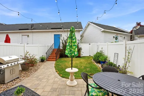 a view of a backyard with plants and a patio