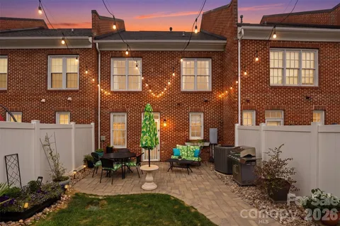 a view of a brick house with many windows and dining table