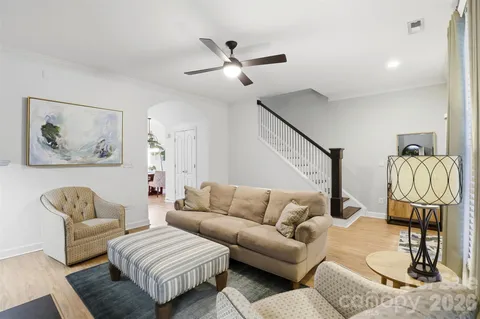 a living room with furniture a rug and a chandelier