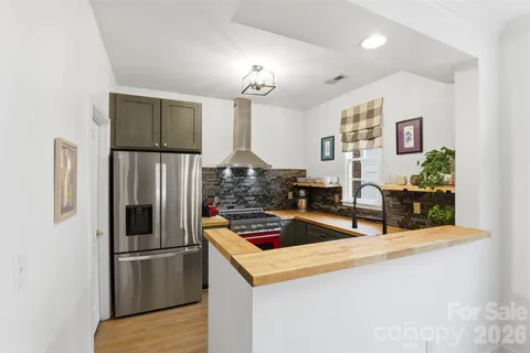 a kitchen with stainless steel appliances granite countertop a refrigerator and a stove