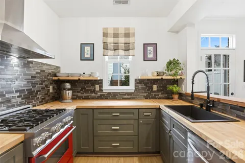 a kitchen with a sink stove and cabinets