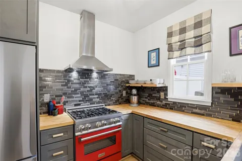 a kitchen with a stove and a shower
