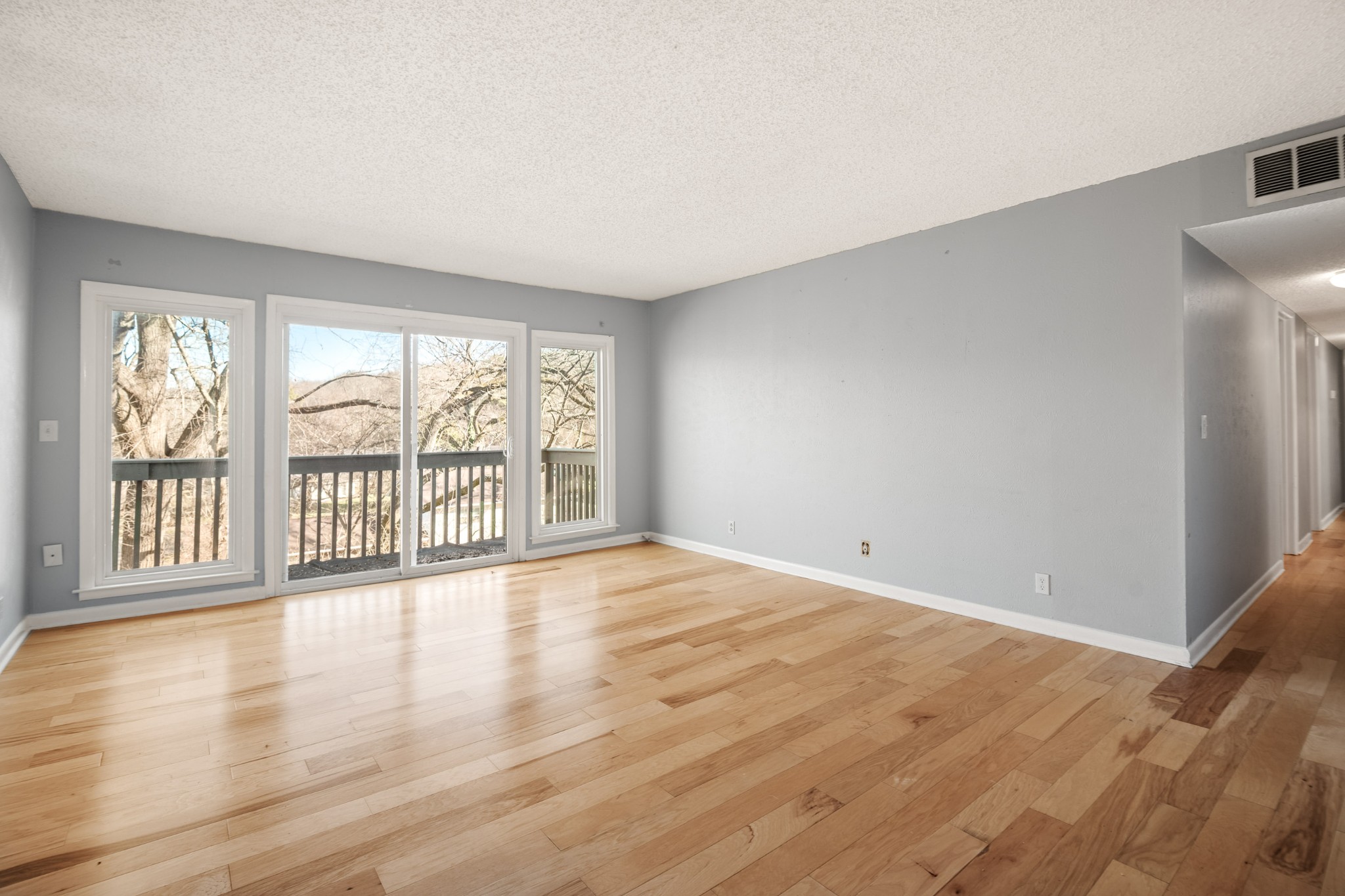 21 Vaughns Gap Road, Unit 23 Nashville, TN 37205 - Photo 1 of 25 a view of an empty room with wooden floor and a window
