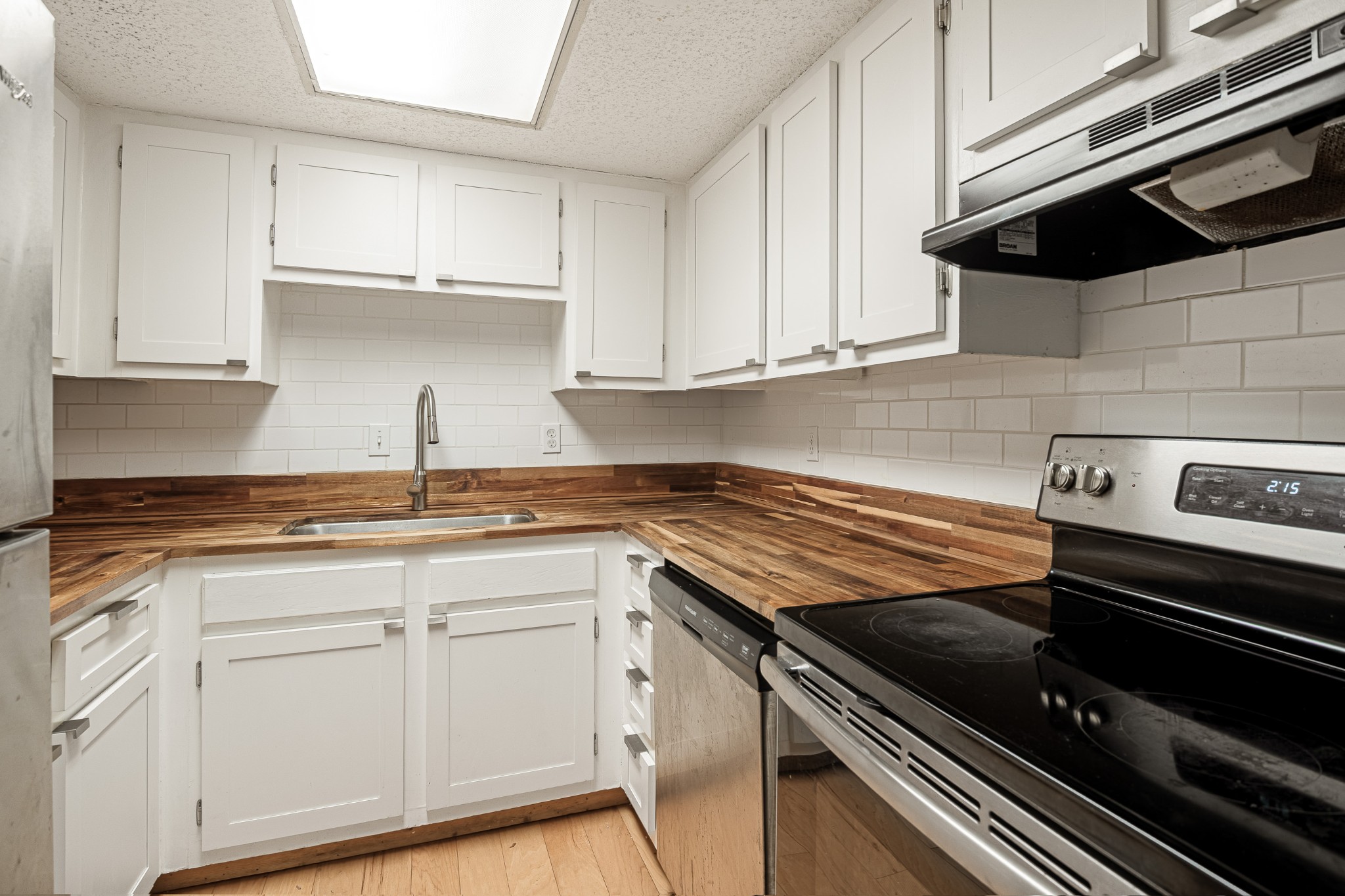 21 Vaughns Gap Road, Unit 23 Nashville, TN 37205 - Photo 11 of 25 a kitchen with white cabinets and appliances