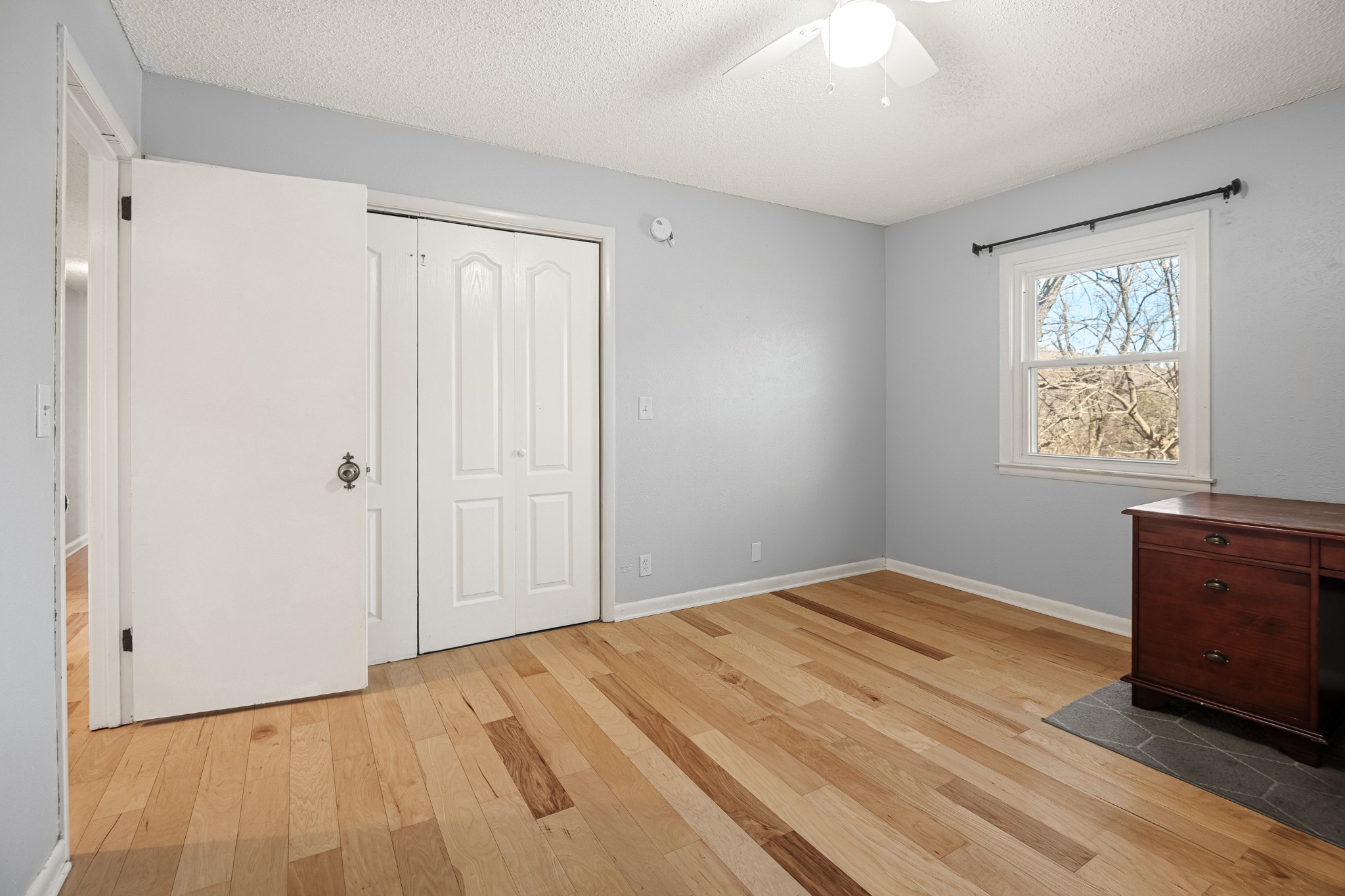 21 Vaughns Gap Road, Unit 23 Nashville, TN 37205 - Photo 18 of 25 a view of empty room with wooden floor and fan