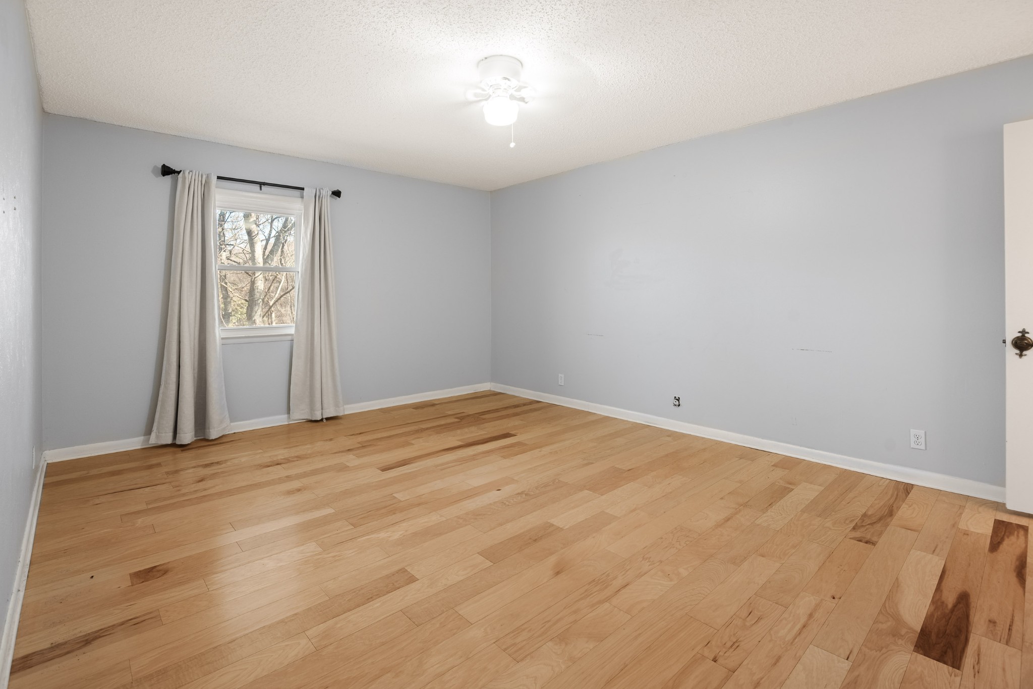 21 Vaughns Gap Road, Unit 23 Nashville, TN 37205 - Photo 20 of 25 a view of empty room with wooden floor and fan