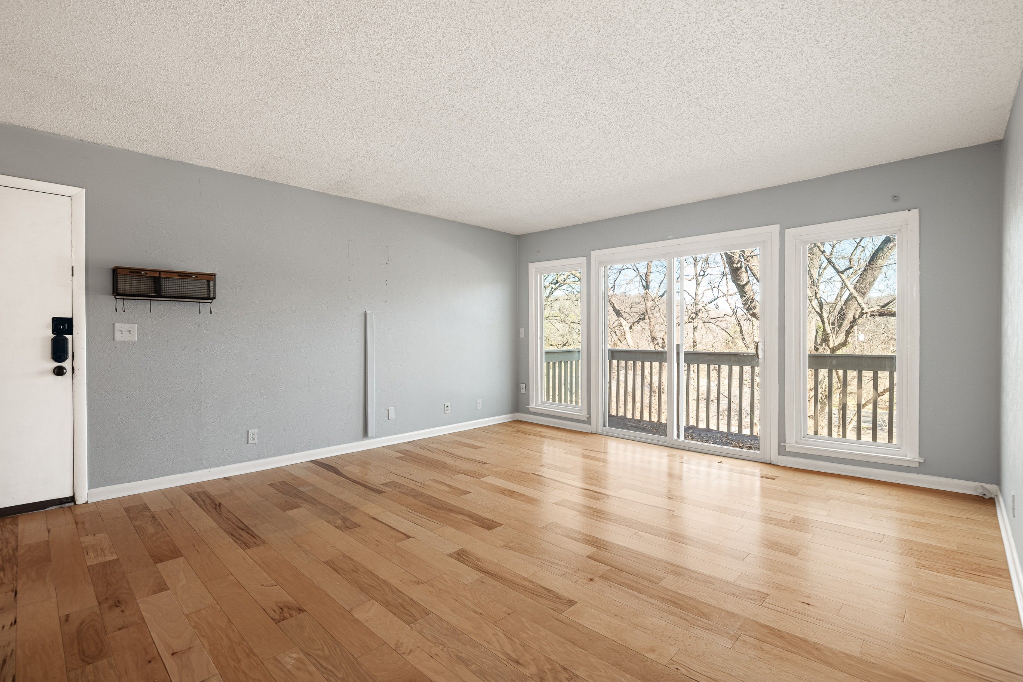 21 Vaughns Gap Road, Unit 23 Nashville, TN 37205 - Photo 4 of 25 a view of an empty room with a window and wooden floor